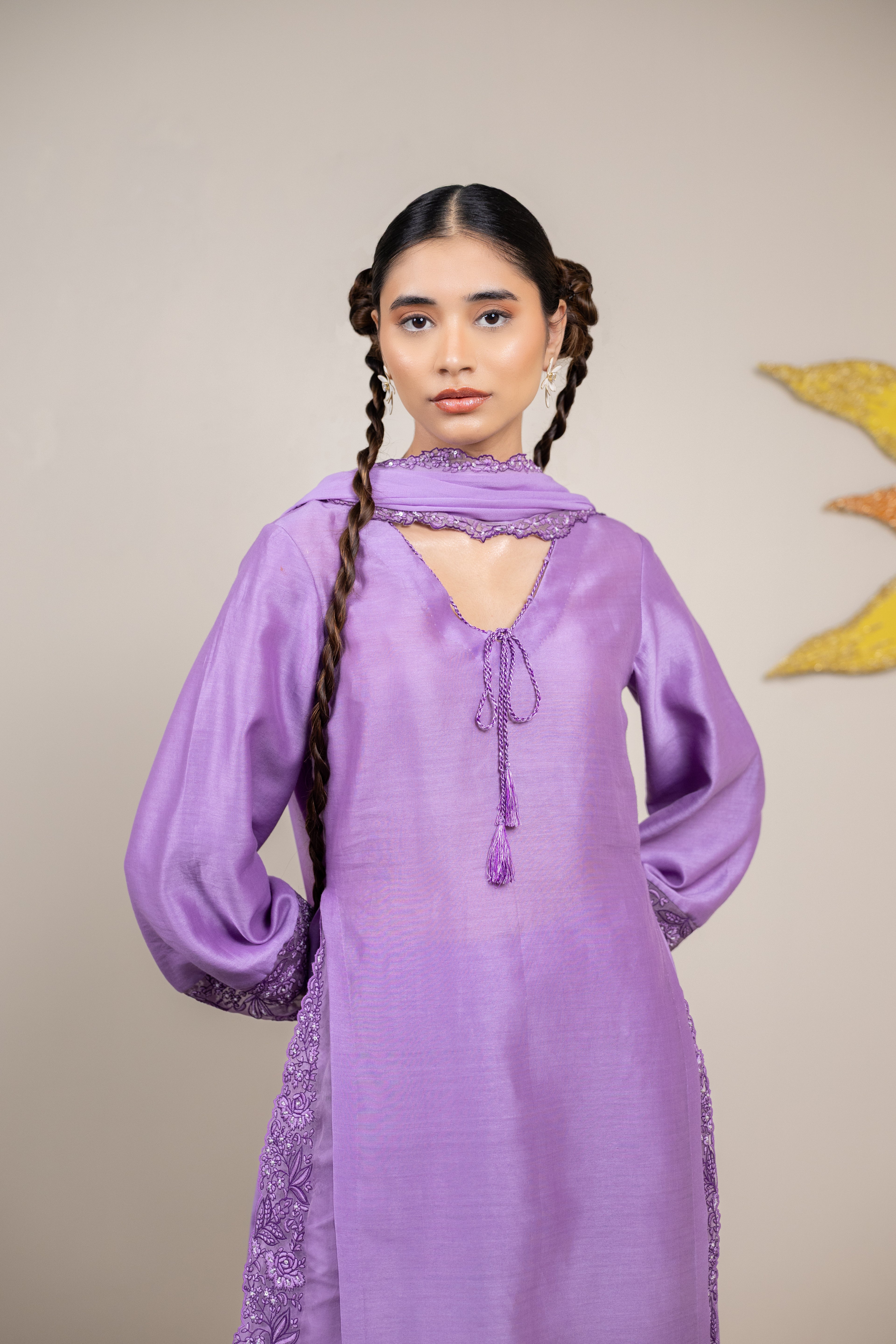 Woman wearing a purple dress with a plain background
